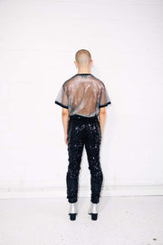 Man wearing black sequin pants with mesh silver t shirt as mens festival outfit