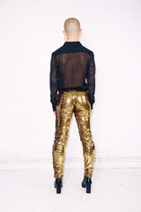 Man wearing gold sequin pants as part of a disco costume