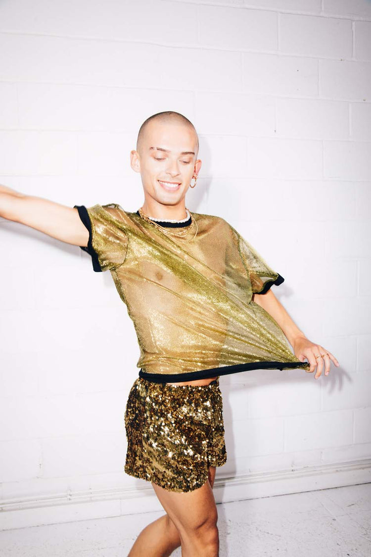 Man wearing sheer gold T-shirt