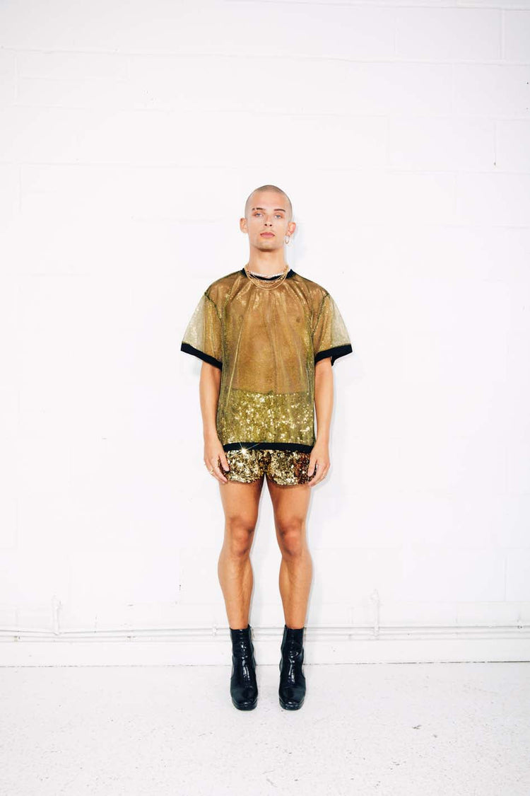 Man wearing sheer gold T-shirt