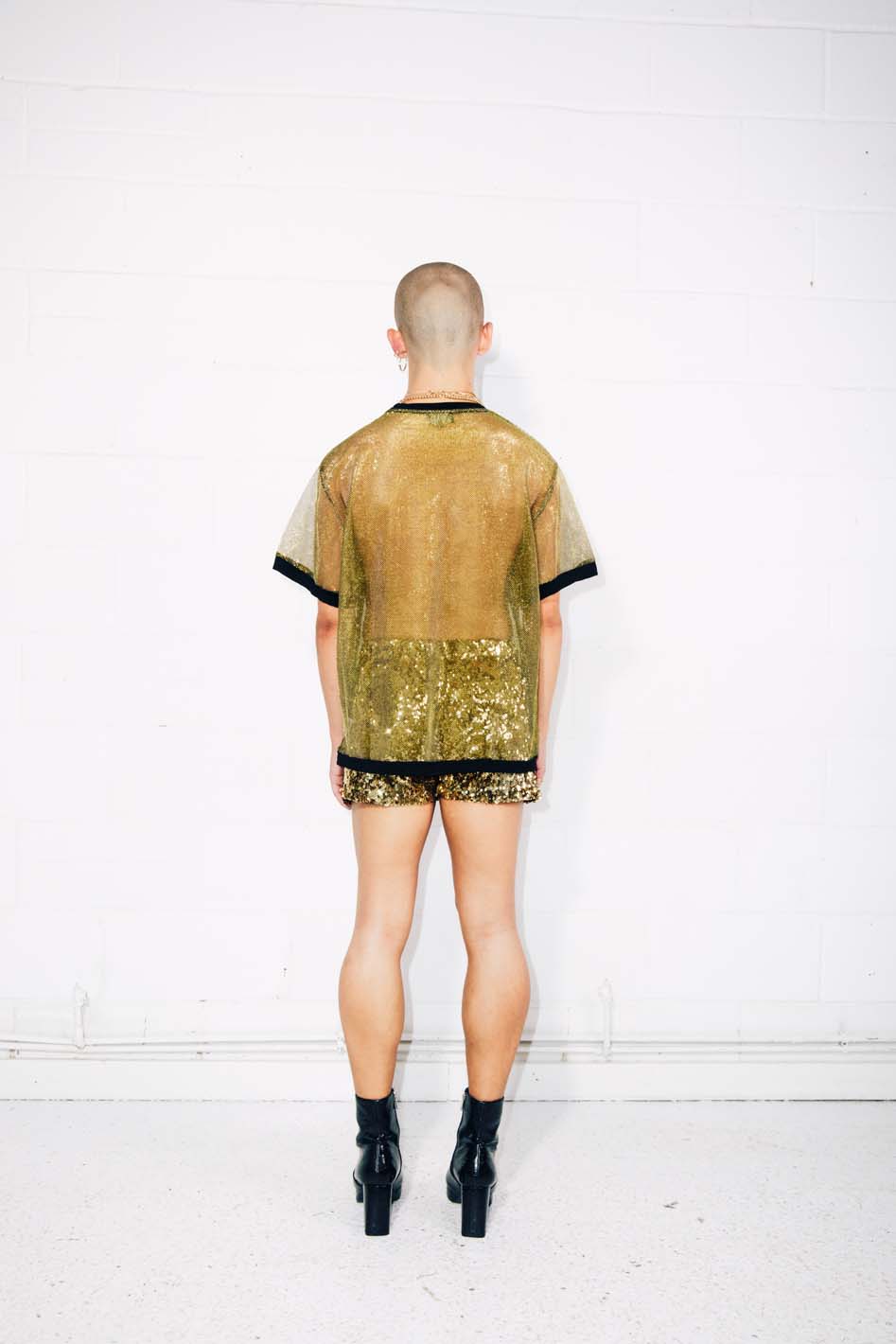 Man wearing sheer gold T-shirt