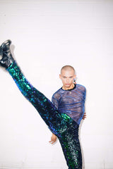 Man wearing green sequin trousers at a party