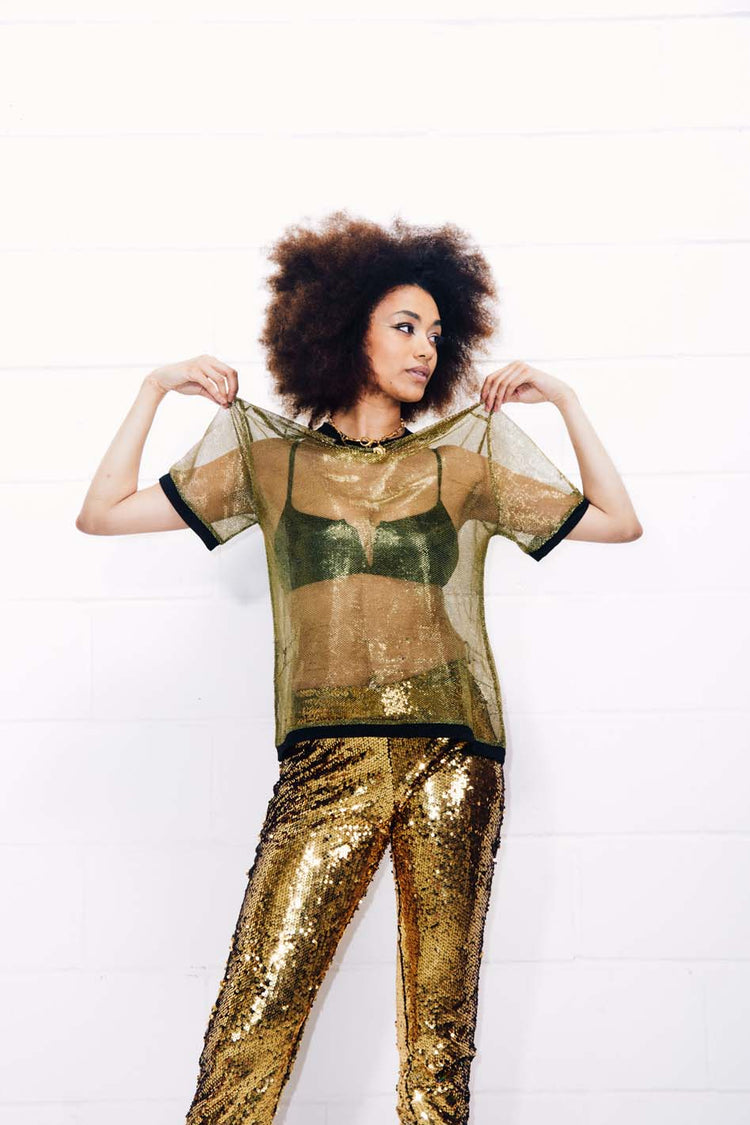 Woman wearing sheer gold T-Shirt