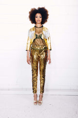 Woman wearing gold sequin pants as part of a studio 54 costume