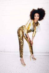 Woman wearing gold sequin pants as part of a disco costume