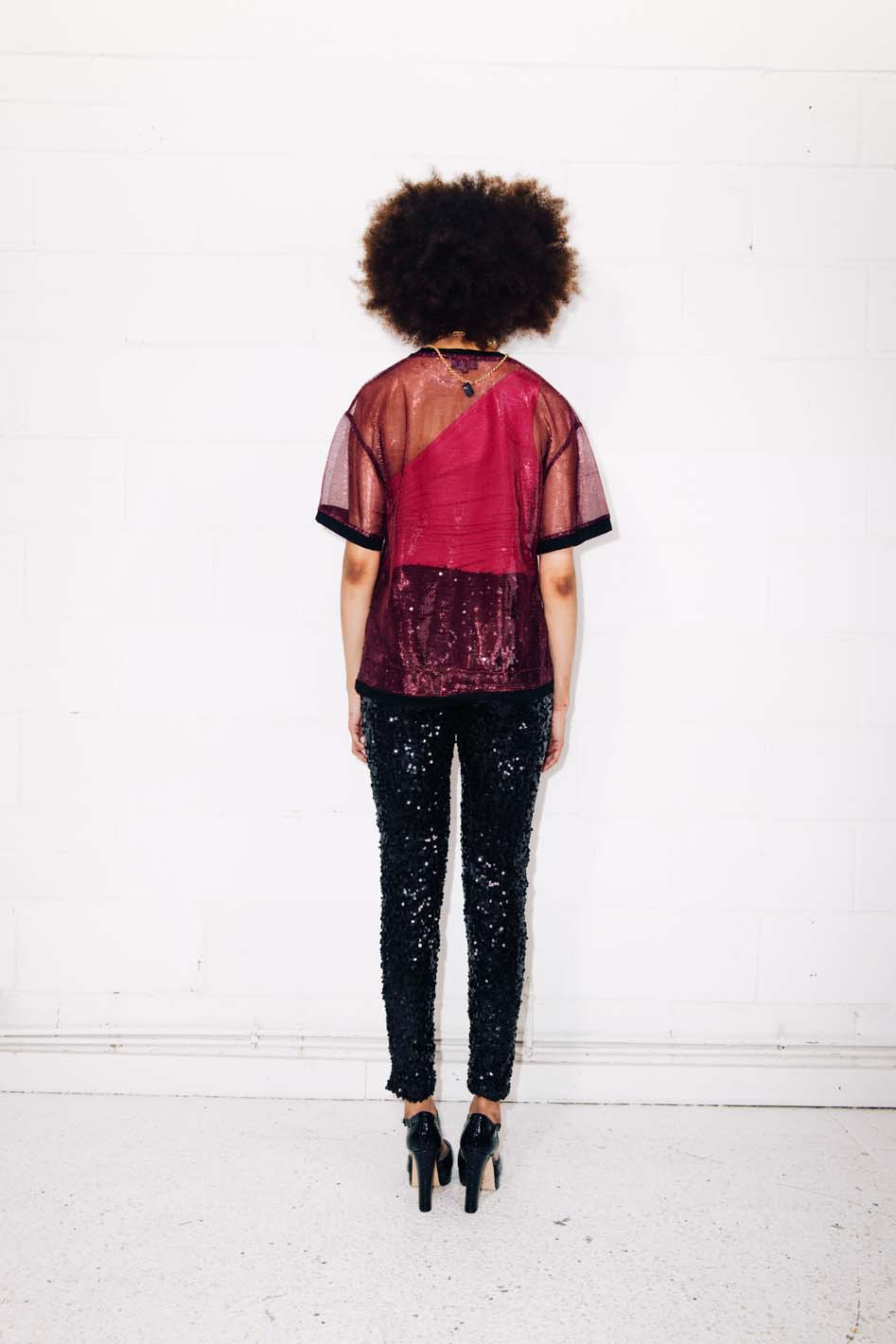 Woman wearing sparkly sheer red T-Shirt