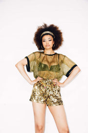 Woman wearing gold sequin shorts